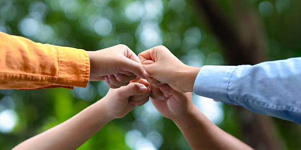 istock Close-up of people colliding in a circle to be environmentally friendly. 2247591121