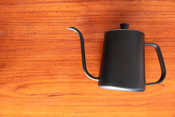 Black kettle pot on wooden table, Top view