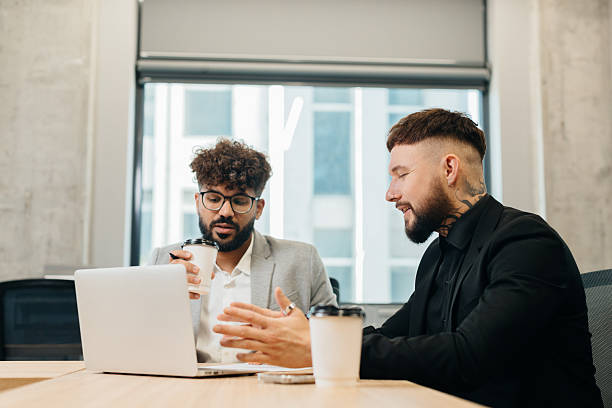istock Diverse businessmen discussing work looking at laptop 2247592854