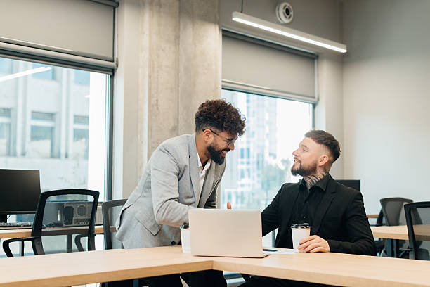 istock Business partners smiling talking shaking hands in office 2247593002