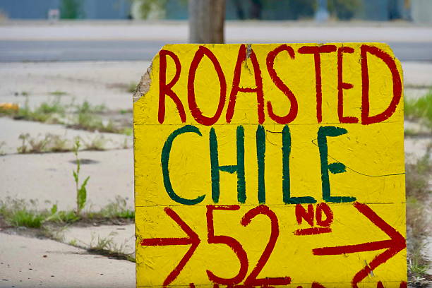 A hand-painted sign advertising fresh roasted chile for sale at an exit off of Interstate 70.