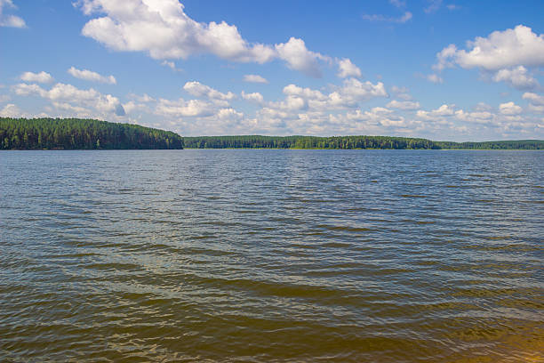 istock Lake sky and trees on the shore 2247594209