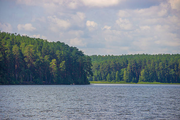 A dock with a sailing ship on a lake.