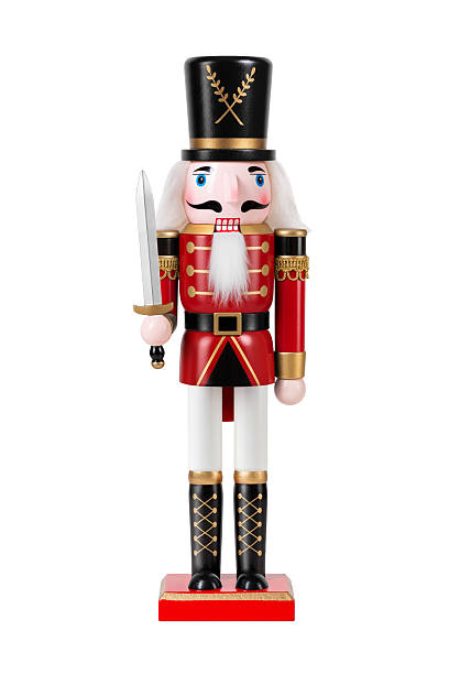 istock Wooden Nutcracker Soldier dressed in white and red uniform isolated on a white background. High resolution. 2247595747