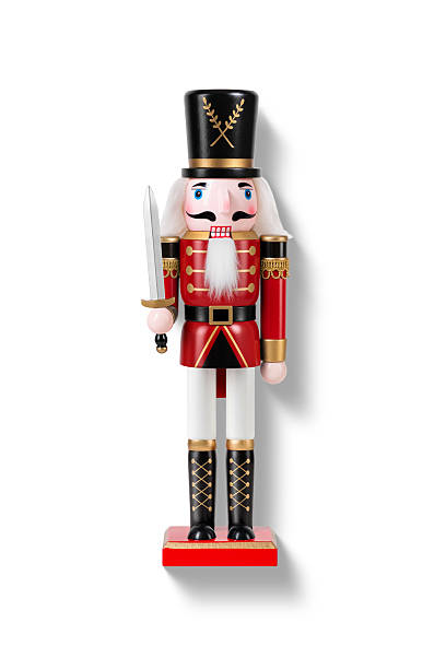 istock Wooden Nutcracker Soldier dressed in white and red uniform isolated on a white background. High resolution. 2247595756