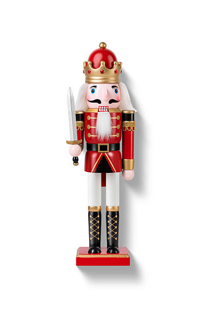 istock Wooden Nutcracker Soldier dressed in white and red uniform isolated on a white background. High resolution. 2247595766