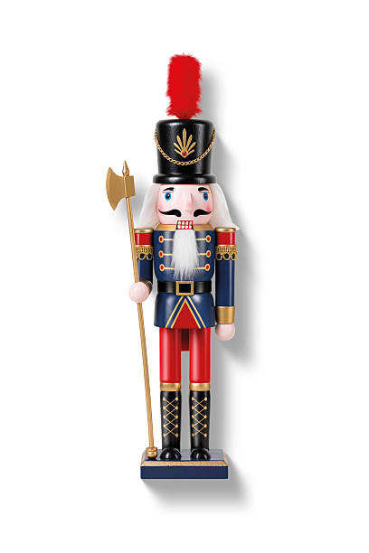 istock Wooden Nutcracker Soldier dressed in a blue and red uniform isolated on a white background. High resolution. 2247595773