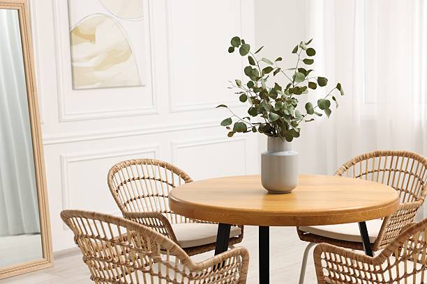 istock Dining room interior with comfortable furniture and eucalyptus branches 2247595774