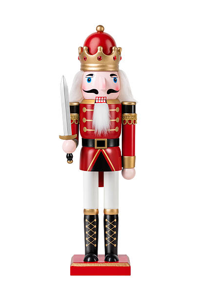 istock Wooden Nutcracker Soldier dressed in white and red uniform isolated on a white background. High resolution. 2247595779