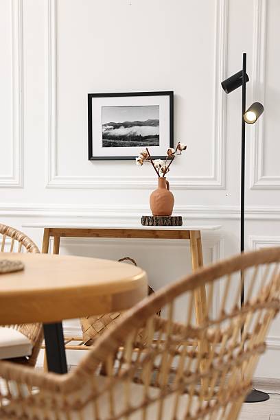 istock Tasty croissants on table and wicker chairs in dining room. Interior design 2247595792