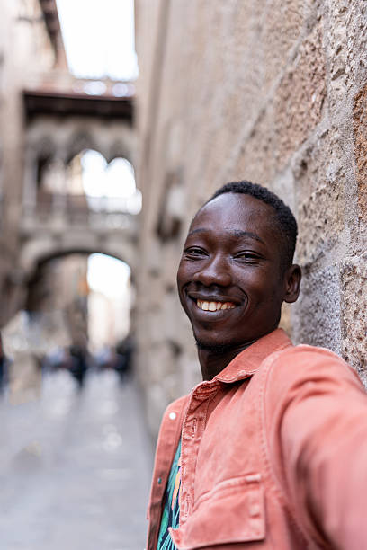 istock African man smiling, taking a selfie during his vacation in Barcelona, Spain 2247595807