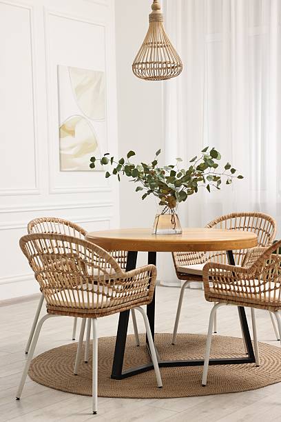 istock Dining room interior with comfortable furniture and eucalyptus branches 2247595823
