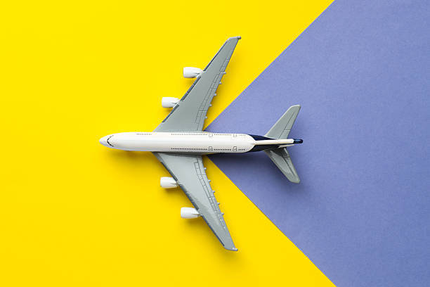 istock Plane model flying on color background, top view 2247595915