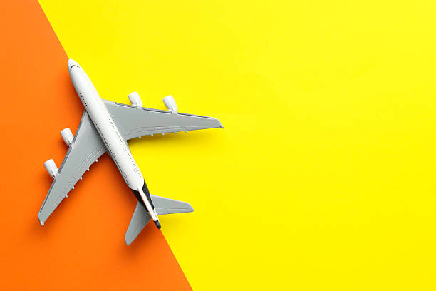 istock Plane model flying on color background, top view. Space for text 2247595926