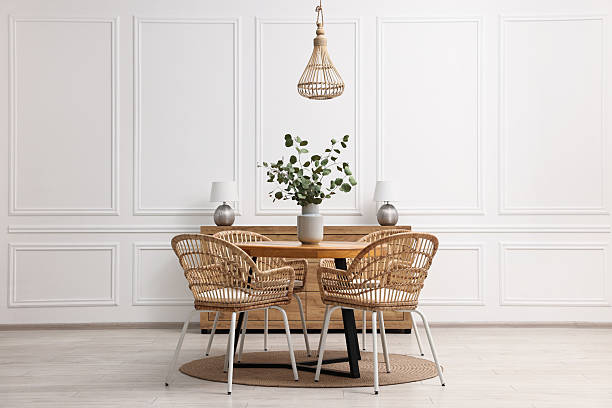 istock Dining room interior with comfortable furniture and eucalyptus branches 2247596199