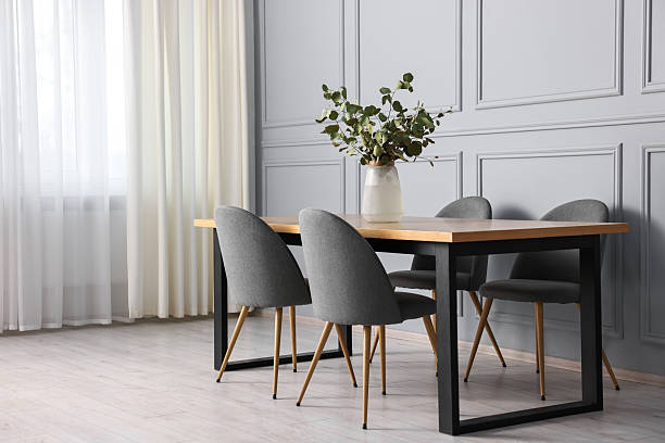 istock Soft chairs, table and vase with eucalyptus branches in stylish dining room 2247596501