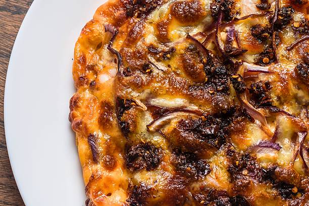 istock Deliciously toasted pizza with caramelized onions and melted cheese 2247597558