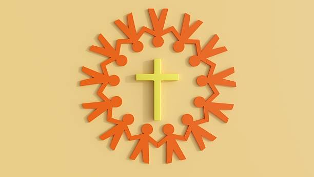 istock A Christian cross is surrounded by human figures arranged in a circle. 2247598624
