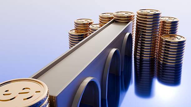 istock An old, simple arch bridge connecting two groups of stacked gold coins. 2247598717