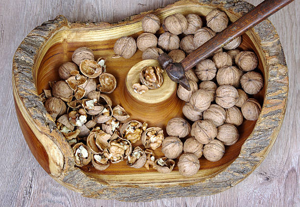 istock walnuts close-up. nut chopping board. walnuts on the board and hammer. top view 2247599385