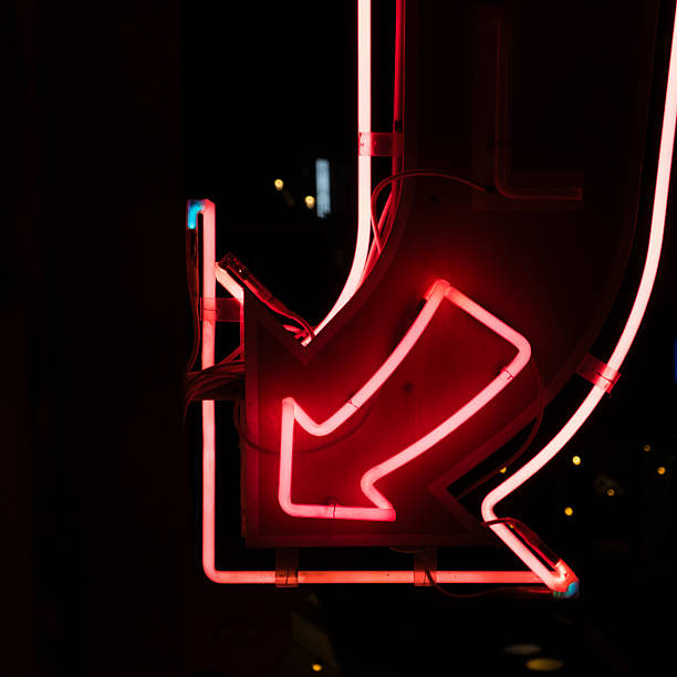 istock Neon Red Arrow Sign on Black 2247599415