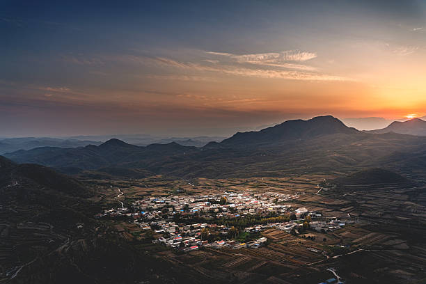 The village nestled in the mountains at sunset