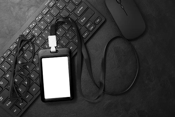 istock Black plastic badge with keyboard on black leather texture background. Template designed for employees of company 2247601383