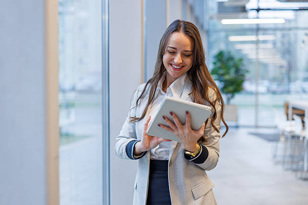 istock Businesswoman using digital tablet in modern office environment 2247601844