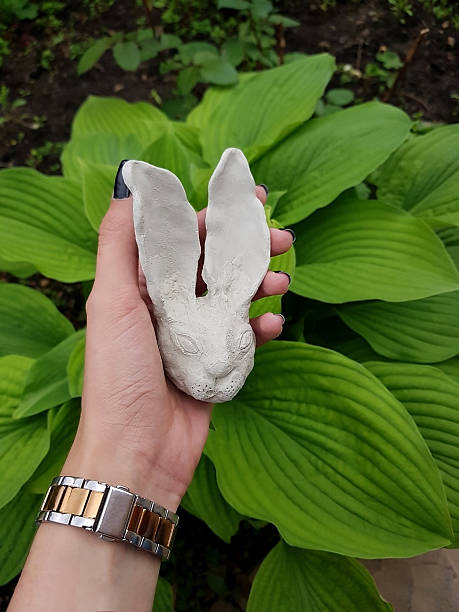 istock Handmade Clay Rabbit Sculpture in Lush Green Garden 2247603272