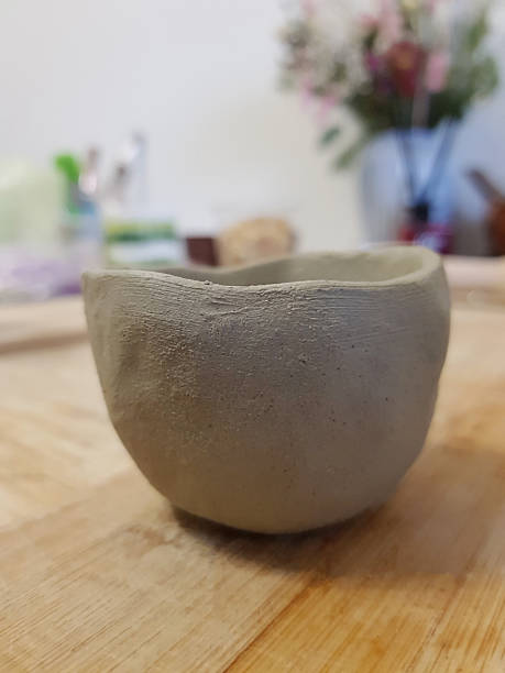 istock Rustic Clay Bowl: Handmade Pottery Art on Wood 2247603728
