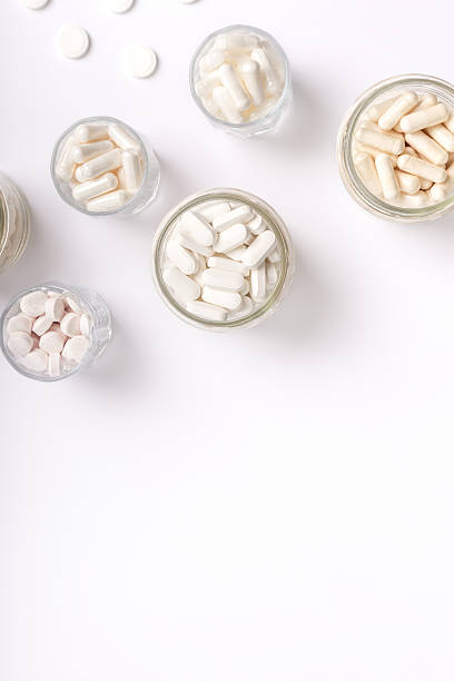 istock White pills, vitamins and dietary supplements on white background. 2247604588