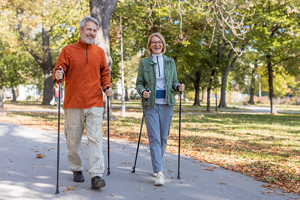 istock Mature couple enjoying Nordic walking in park 2247607608