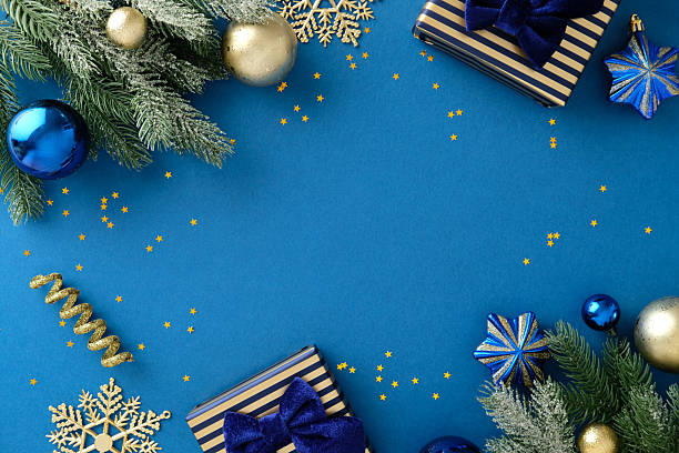 istock Flat lay festive blue Christmas decorations with gold gifts and bauble 2247607929