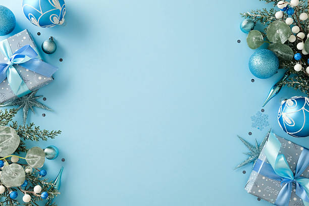 istock Horizontal side-border with Christmas gifts, blue and silver baubles on light blue background 2247608506