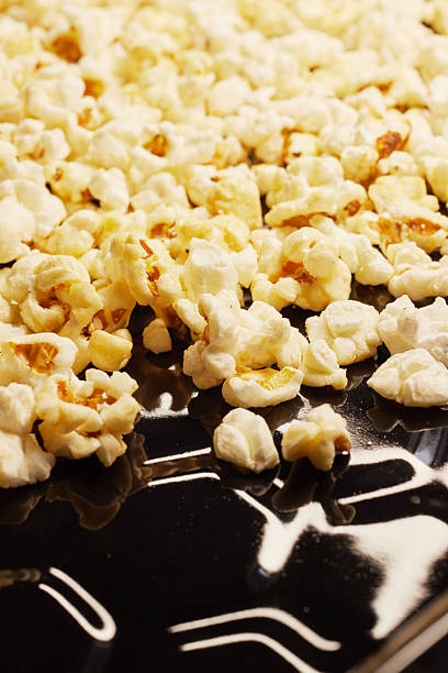 istock Close-up of fresh popcorn on a black baking tray 2247608848