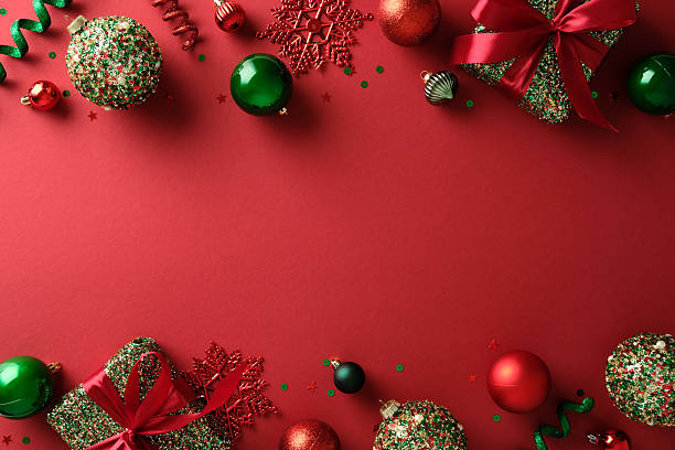 istock Vibrant Christmas flat lay with gift boxes and baubles on red backdrop. 2247609021