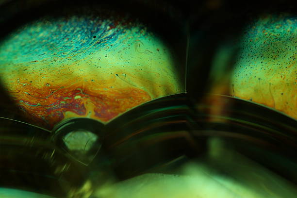 istock Green liquid luminous chemical effect on dark background, iridescent objects 2247610783