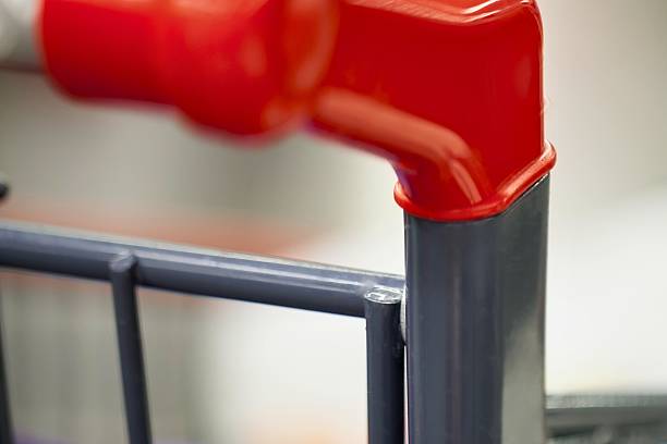 istock Close up of red shopping cart handle and frame 2247611083