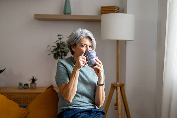 istock Senior woman relaxing at home drinking coffee 2247611438