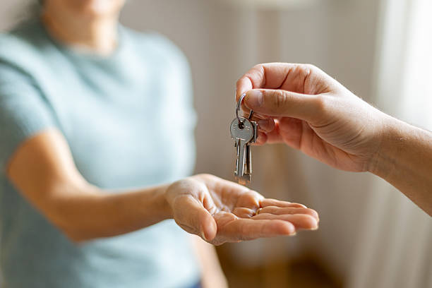 istock Handing over house keys for a new home 2247611488