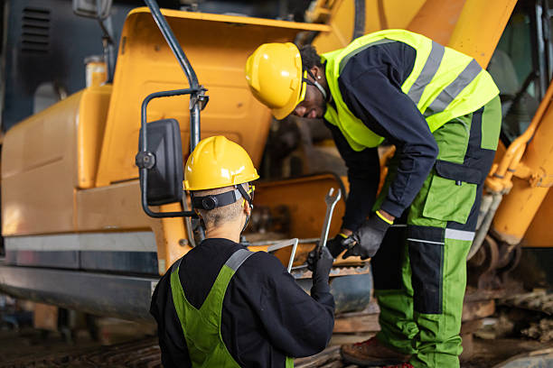 istock Team of colleagues engineers in the workshop next to the excavator 2247613037