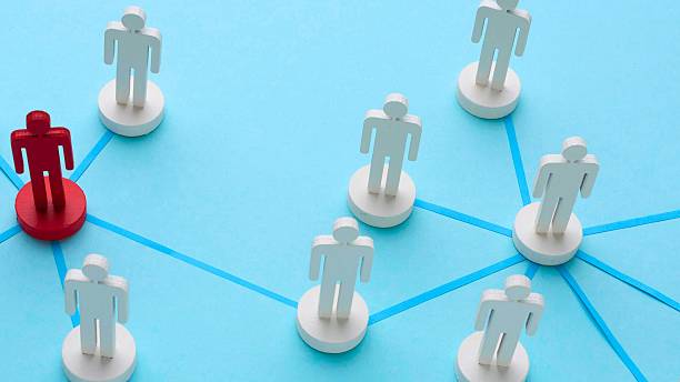 istock Unique red figure connects to network of white figures 2247615005