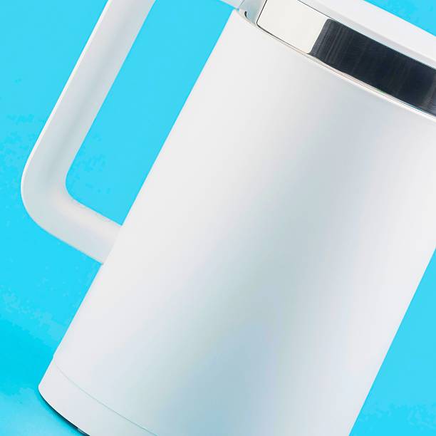 istock Modern white electric kettle with blue background close up 2247615339