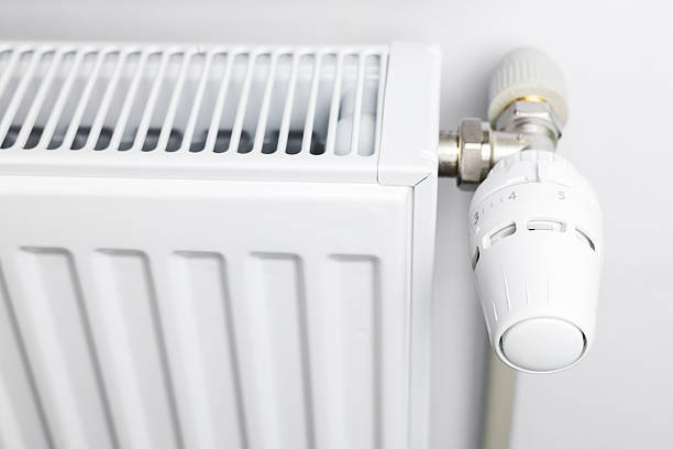 istock Heating radiator with thermal head close up 2247615719
