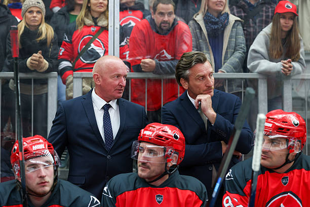 istock Ice Hockey Coaching Staff Engaged in Strategic Discussion on Bench 2247615999