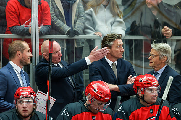istock Ice Hockey Coaching Staff in Focused Bench Discussion During Game 2247616006