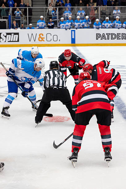 istock Intense Ice Hockey Faceoff with Determined Players 2247616034