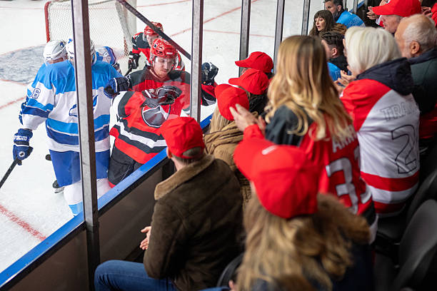 istock Ice Hockey Player Joyfully Engaging with Enthusiastic Crowd 2247616036