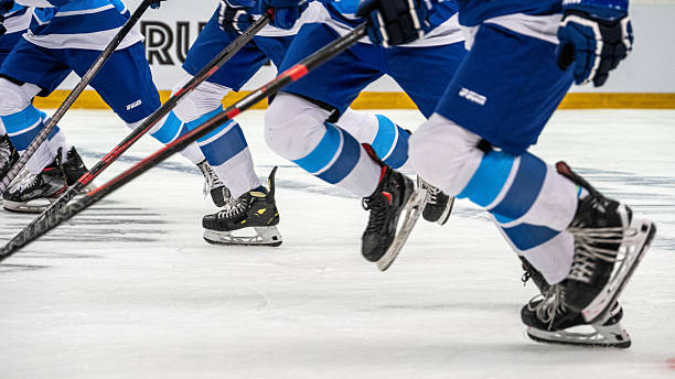 istock Ice Hockey Players Sliding Energetically During Warm up Session 2247616076