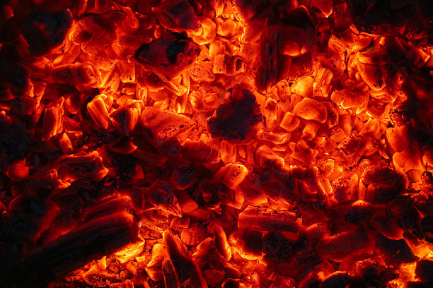 istock Burning coals in the dark, smoldering coal. Bright red sparks of fire. Background 2247616943